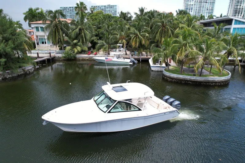 37 Grady White Freedom Yacht Photos Pics 2017 Grady-White Freedom 375 boat cruising in a tropical marina setting.