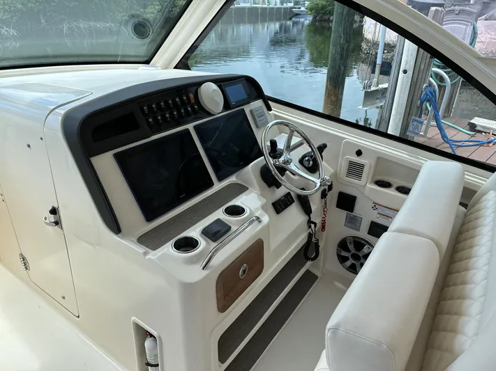 37 Grady White Freedom Yacht Photos Pics 2017 Grady-White Freedom 375 helm with dual screens and steering wheel, dockside view.