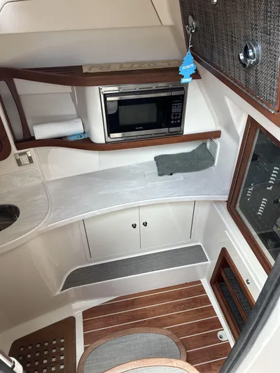 37 Grady White Freedom Yacht Photos Pics 2017 Grady-White Freedom 375 cabin interior with microwave and wood accents.