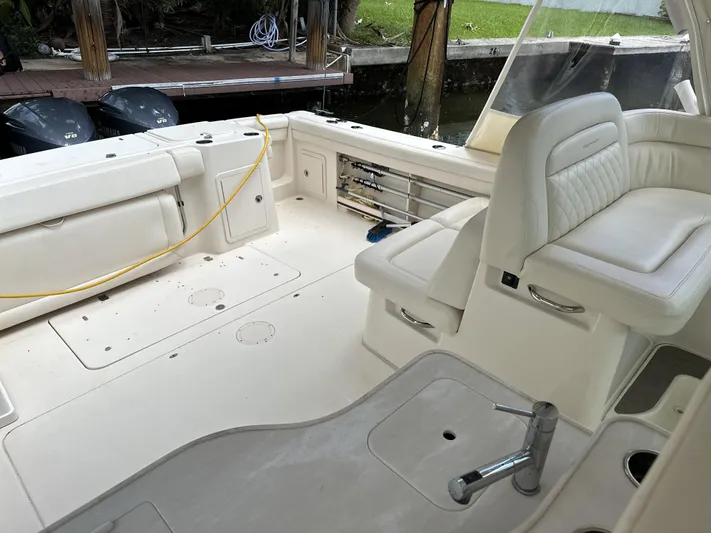 37 Grady White Freedom Yacht Photos Pics 2017 Grady-White Freedom 375 boat interior with white seating and deck, docked by water.