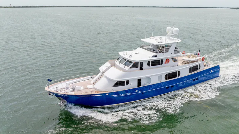 Bravo Yacht Photos Pics 1975 Stephens Brothers Expedition yacht cruising on open water, featuring a sleek blue and white design.