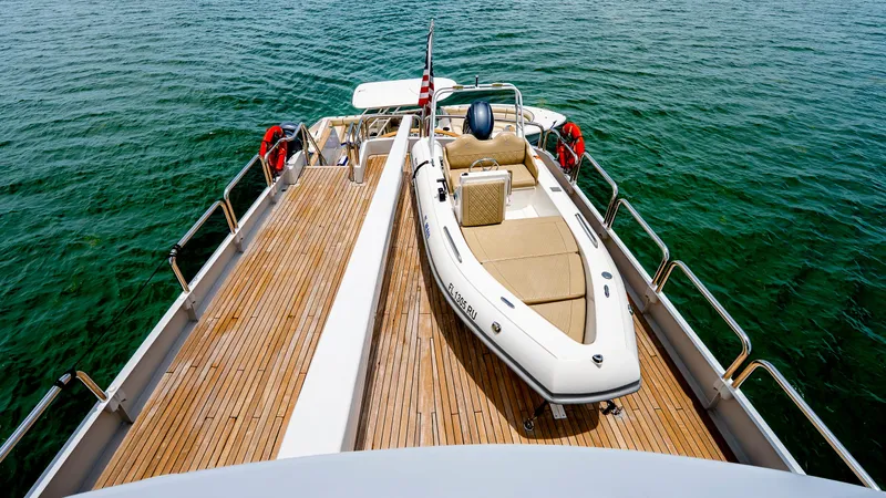 Bravo Yacht Photos Pics 1975 Stephens Brothers Expedition yacht deck with tender boat on calm water.