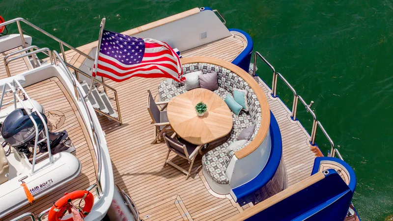 Bravo Yacht Photos Pics 1975 Stephens Brothers Expedition yacht deck with American flag and seating area.