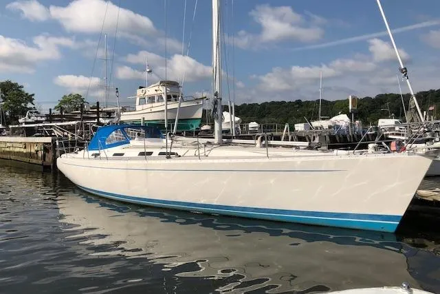 Dark N' Stormy III Yacht Photos Pics Sailing yacht docked at marina, Sweden Yachts 45, 1999 model, under clear skies.
