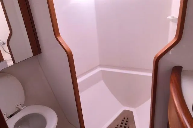 Dark N' Stormy III Yacht Photos Pics Bathroom interior of 1999 Sweden Yachts 45, featuring shower and toilet.