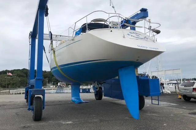 Dark N' Stormy III Yacht Photos Pics 1999 Sweden Yachts 45 sailboat on a lift at a marina.