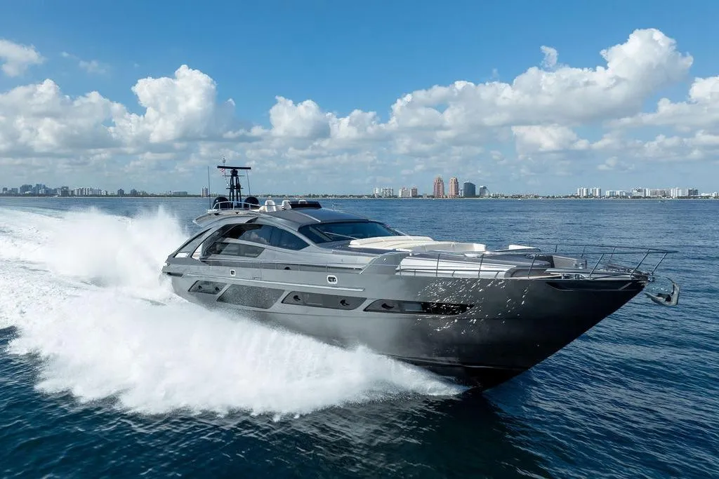 Luxury 2019 Pershing 9X yacht cruising on open water under a clear blue sky.