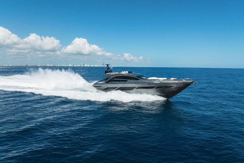 2019 Pershing 9X yacht cruising on open sea under clear blue sky.