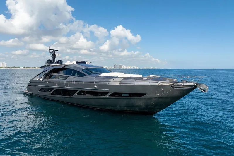 One Spin 3 Yacht Photos Pics 2019 Pershing 9X luxury yacht cruising on open sea under clear blue sky.
