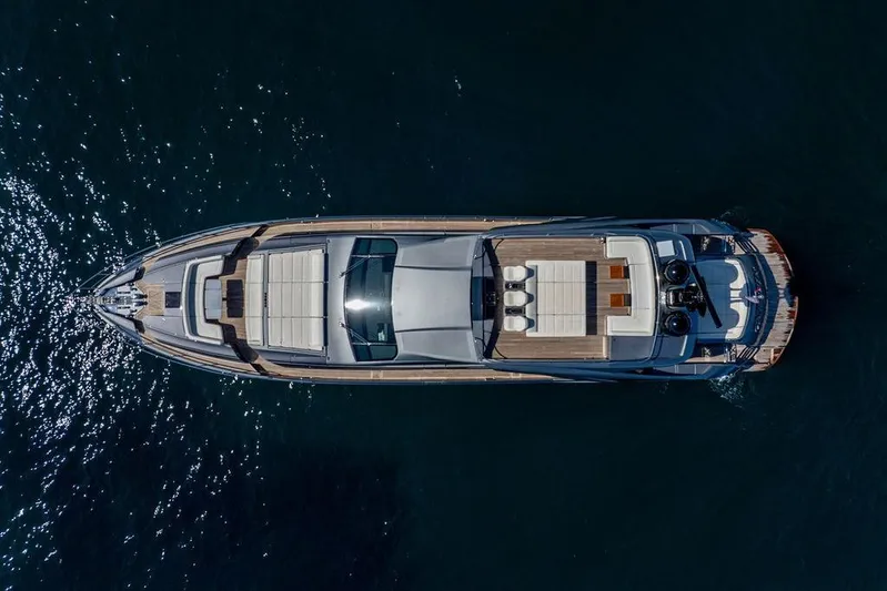 One Spin 3 Yacht Photos Pics Aerial view of 2019 Pershing 9X luxury yacht on dark water.