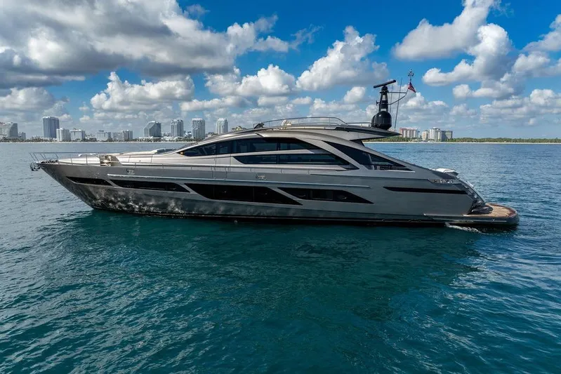 One Spin 3 Yacht Photos Pics 2019 Pershing 9X yacht on calm water with city skyline background.