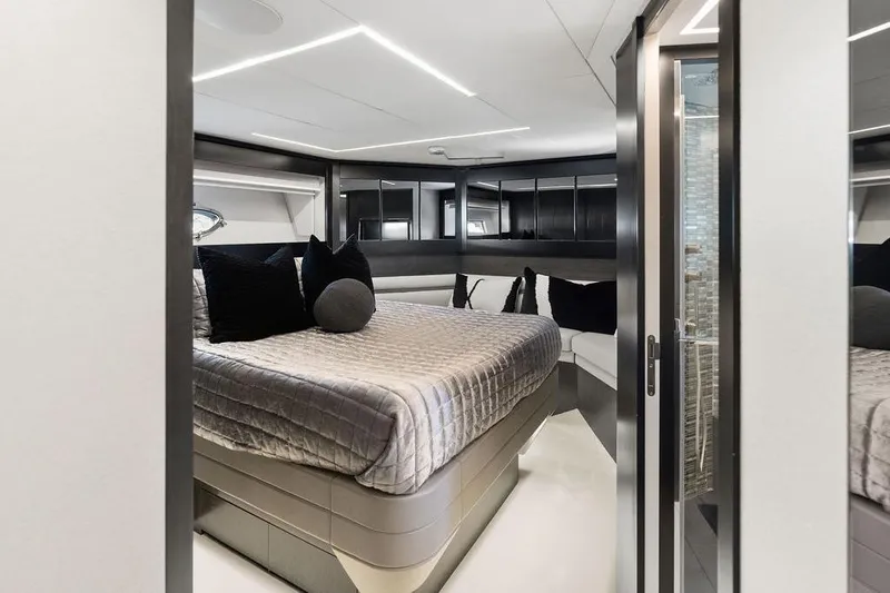 One Spin 3 Yacht Photos Pics Luxurious bedroom interior of 2019 Pershing 9X yacht with modern design and elegant furnishings.