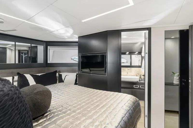 One Spin 3 Yacht Photos Pics Luxurious interior of 2019 Pershing 9X yacht bedroom with modern design and elegant furnishings.