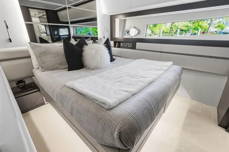 One Spin 3 Yacht Photos Pics Luxurious bedroom interior of 2019 Pershing 9X yacht with modern decor and large window.