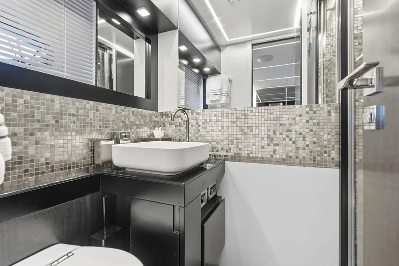 One Spin 3 Yacht Photos Pics Luxurious bathroom in 2019 Pershing 9X yacht with modern fixtures and mosaic tiles.