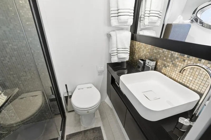 One Spin 3 Yacht Photos Pics Luxurious bathroom in 2019 Pershing 9X yacht with modern fixtures and elegant design.