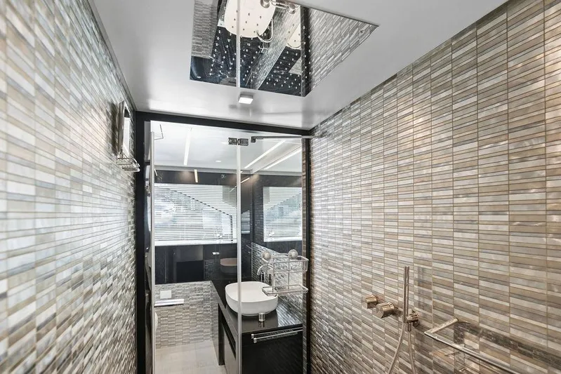 One Spin 3 Yacht Photos Pics Luxurious bathroom interior on 2019 Pershing 9X yacht with modern tile design.