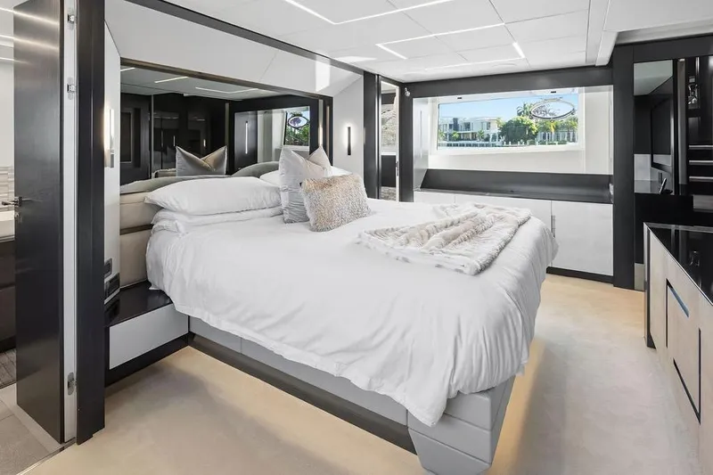 One Spin 3 Yacht Photos Pics Luxurious bedroom interior on 2019 Pershing 9X yacht, featuring modern design and elegant decor.