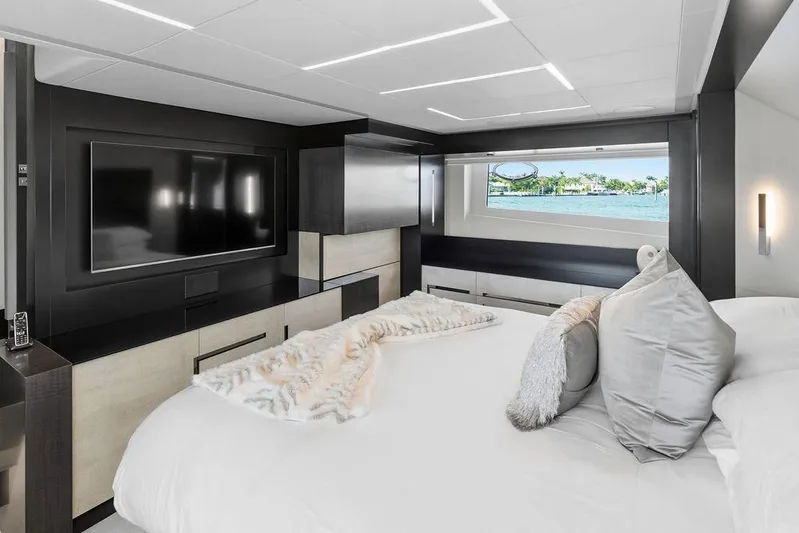 One Spin 3 Yacht Photos Pics Luxurious bedroom interior of 2019 Pershing 9X yacht with modern decor and large window view.