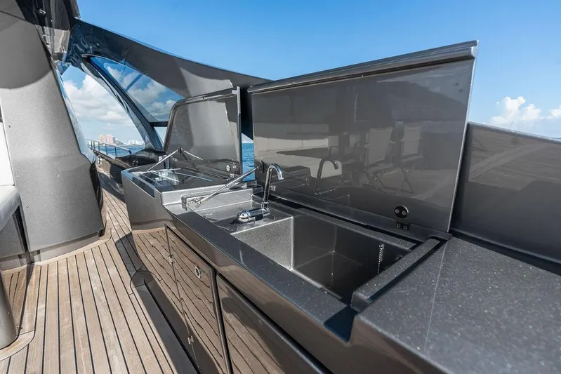 One Spin 3 Yacht Photos Pics Luxurious outdoor kitchen on 2019 Pershing 9X yacht with sleek countertops and sink.