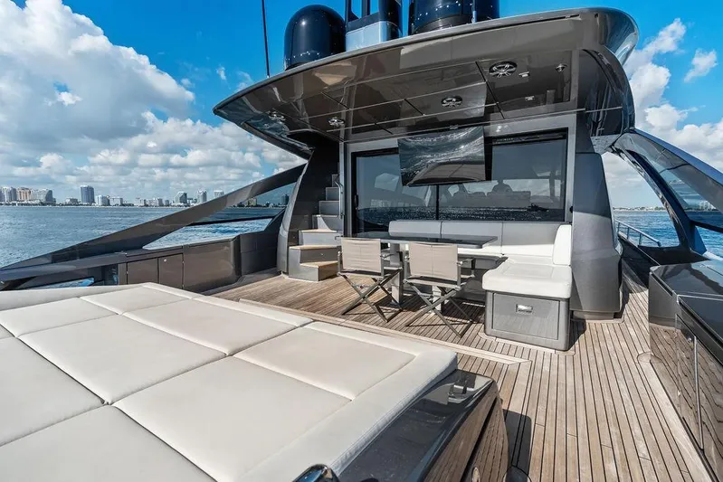 One Spin 3 Yacht Photos Pics Luxurious 2019 Pershing 9X yacht deck with seating, table, and ocean view.