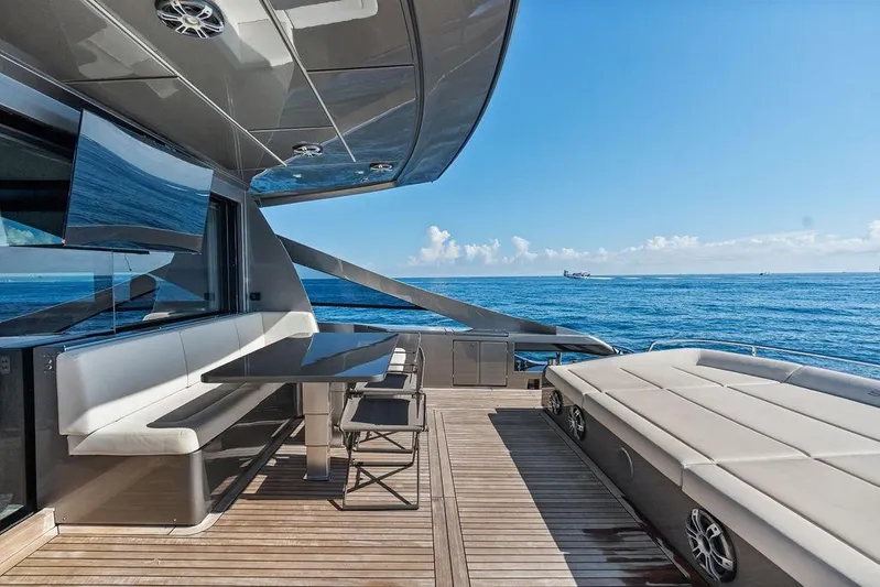 One Spin 3 Yacht Photos Pics Luxurious 2019 Pershing 9X yacht deck with seating, ocean view, and modern design.