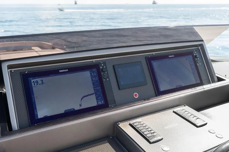 One Spin 3 Yacht Photos Pics Control panel of a 2019 Pershing 9X yacht with navigation screens.
