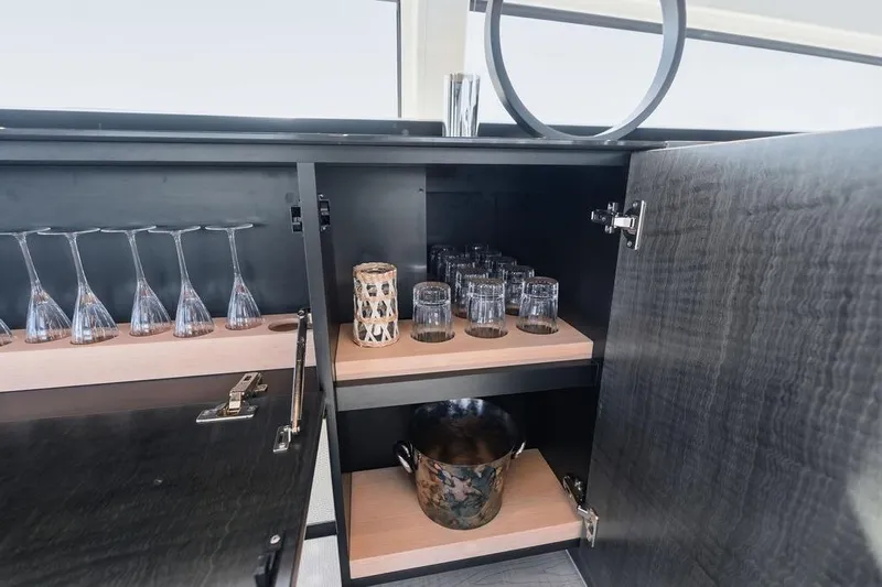 One Spin 3 Yacht Photos Pics Luxury yacht Pershing 9X 2019 interior bar with glassware and ice bucket.
