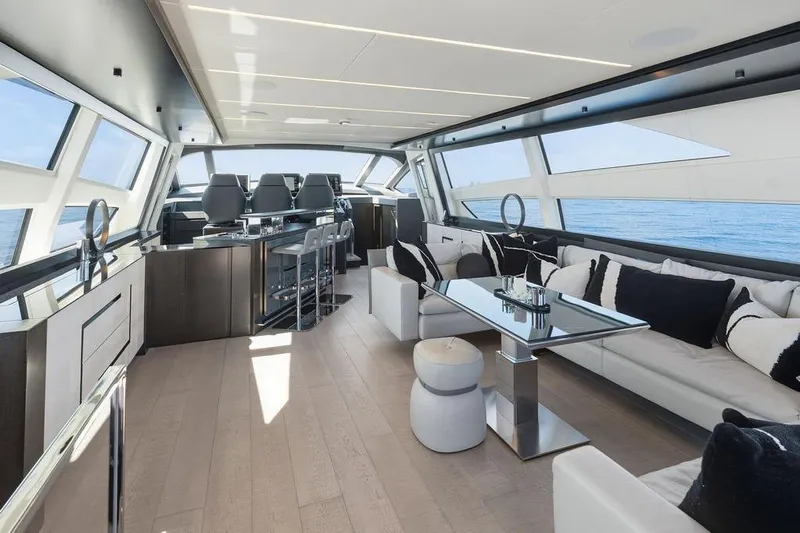 One Spin 3 Yacht Photos Pics Luxurious interior of 2019 Pershing 9X yacht with modern seating and panoramic windows.