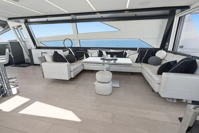 One Spin 3 Yacht Photos Pics Luxurious interior of 2019 Pershing 9X yacht with modern seating and ocean view.