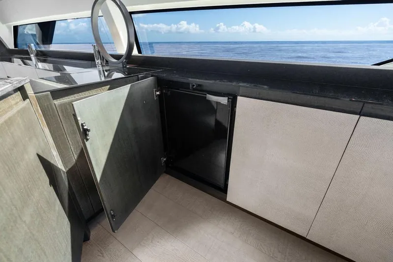 One Spin 3 Yacht Photos Pics Luxurious 2019 Pershing 9X yacht interior with open cabinets and ocean view.