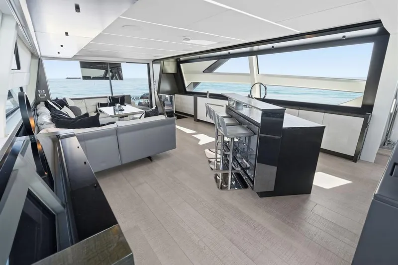 One Spin 3 Yacht Photos Pics Luxurious interior of 2019 Pershing 9X yacht with modern seating and ocean view.