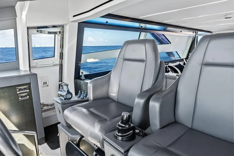 One Spin 3 Yacht Photos Pics Luxurious interior of 2019 Pershing 9X yacht with leather seating and ocean view.