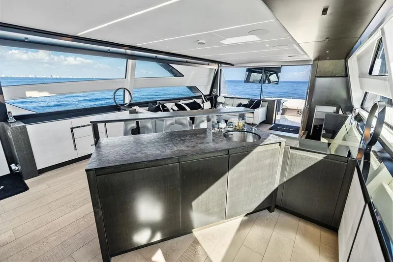 One Spin 3 Yacht Photos Pics Luxurious interior of 2019 Pershing 9X yacht with ocean view and modern design.