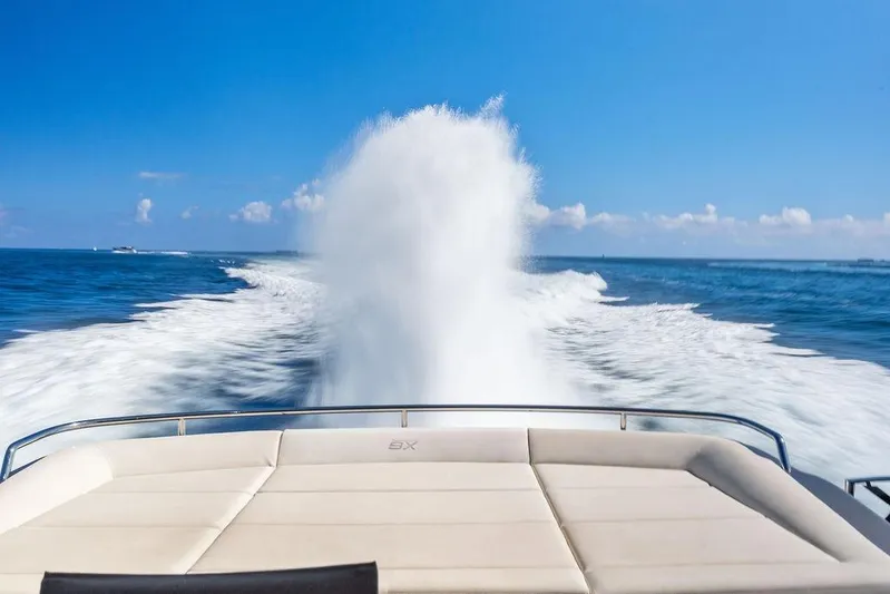 One Spin 3 Yacht Photos Pics 2019 Pershing 9X yacht cruising on open sea, leaving a foamy wake.