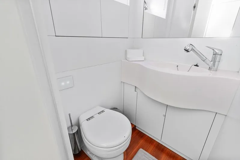 One Spin 3 Yacht Photos Pics Modern bathroom in 2019 Pershing 9X yacht with sleek fixtures and white cabinetry.