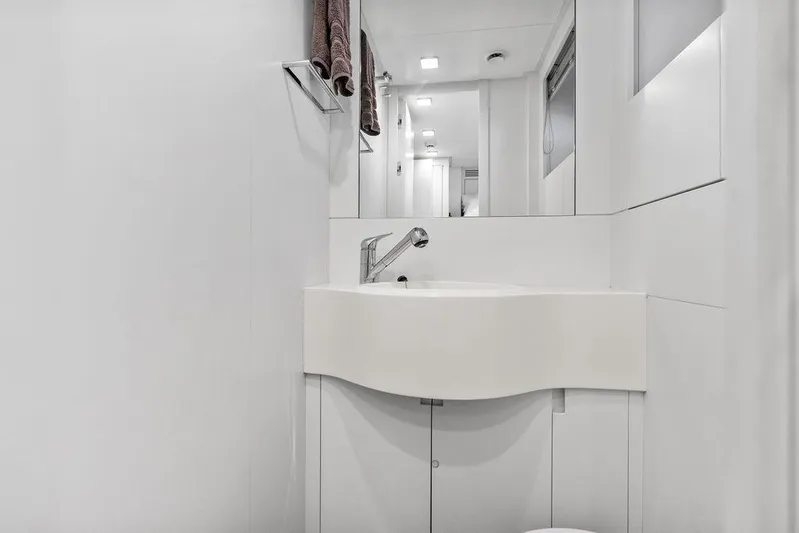 One Spin 3 Yacht Photos Pics Modern bathroom interior on 2019 Pershing 9X yacht, featuring sleek white design and fixtures.