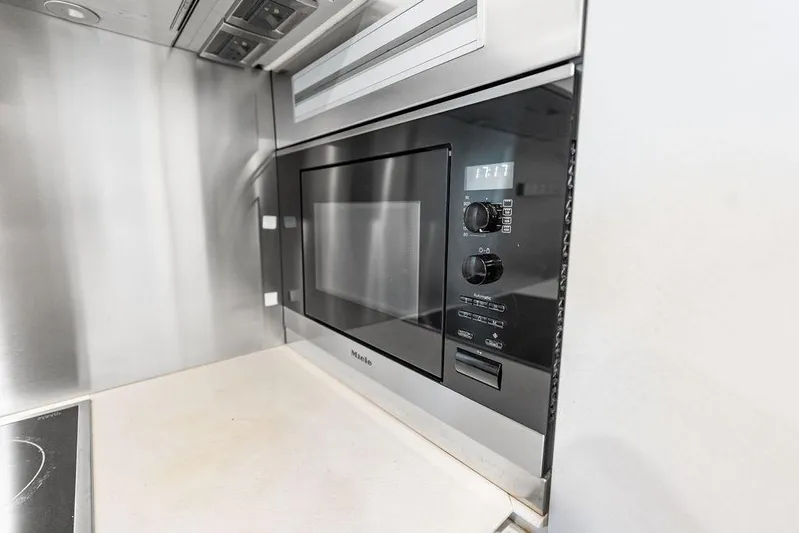 One Spin 3 Yacht Photos Pics Built-in Miele microwave in a 2019 Pershing 9X yacht kitchen.