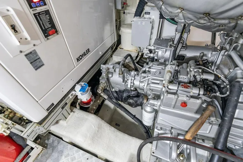 One Spin 3 Yacht Photos Pics Engine room of 2019 Pershing 9X yacht featuring Kohler generator and mechanical components.