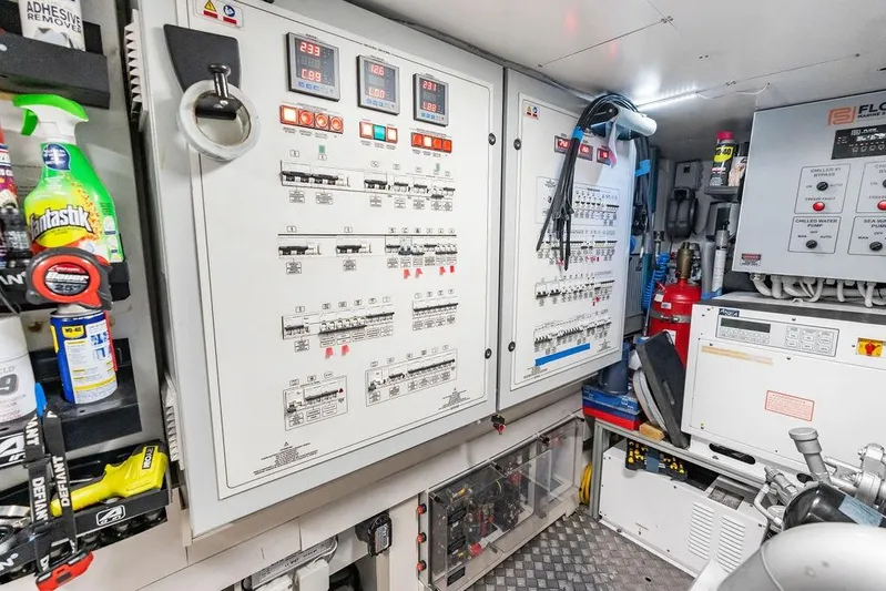 One Spin 3 Yacht Photos Pics Electrical control room of a 2019 Pershing 9X yacht, featuring panels and equipment.