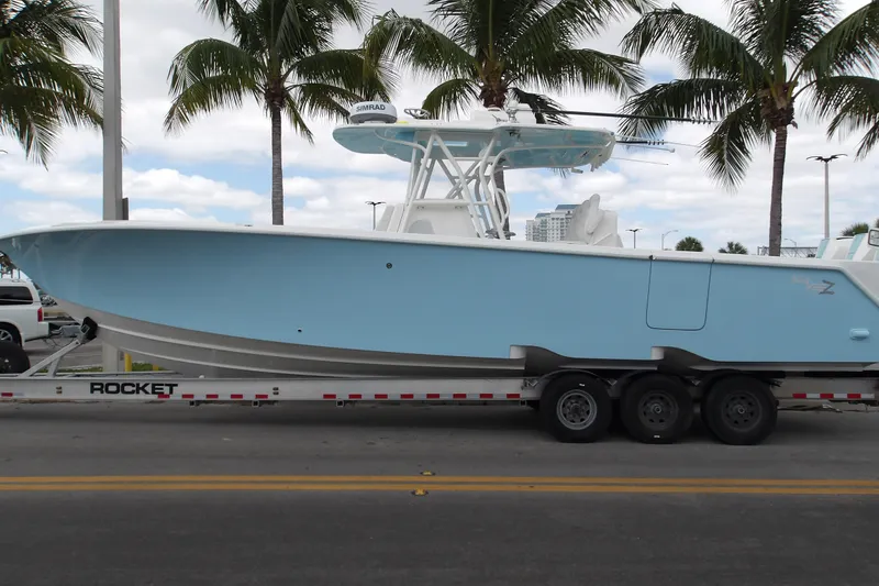  Yacht Photos Pics 2022 SeaVee 370z boat on trailer, parked under palm trees.