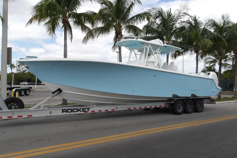  Yacht Photos Pics 2022 SeaVee 370z boat on trailer, parked near palm trees.