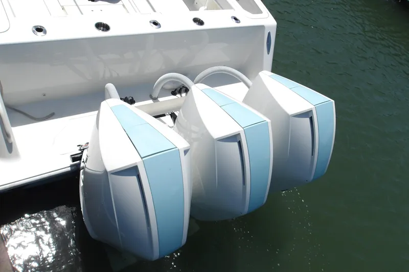  Yacht Photos Pics Triple outboard engines on a 2022 SeaVee 370z boat, docked in water.