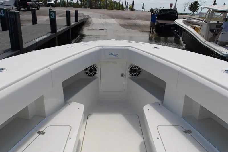  Yacht Photos Pics 2022 SeaVee 370z boat interior at dock, showcasing spacious seating and storage.