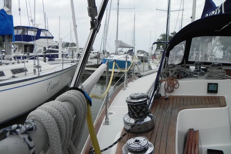 Cricket Yacht Photos Pics 1988 Tartan 40 sailboat docked in marina, surrounded by other boats.