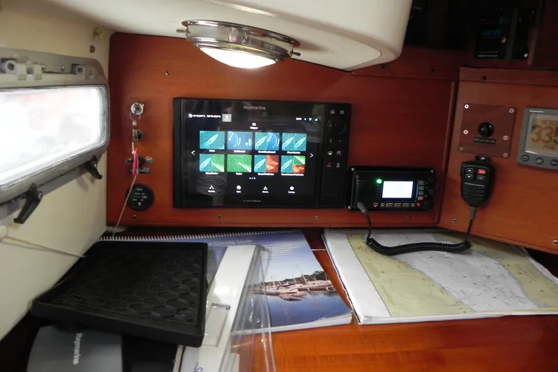 Cricket Yacht Photos Pics Interior of 1988 Tartan 40 sailboat with navigation equipment and charts.