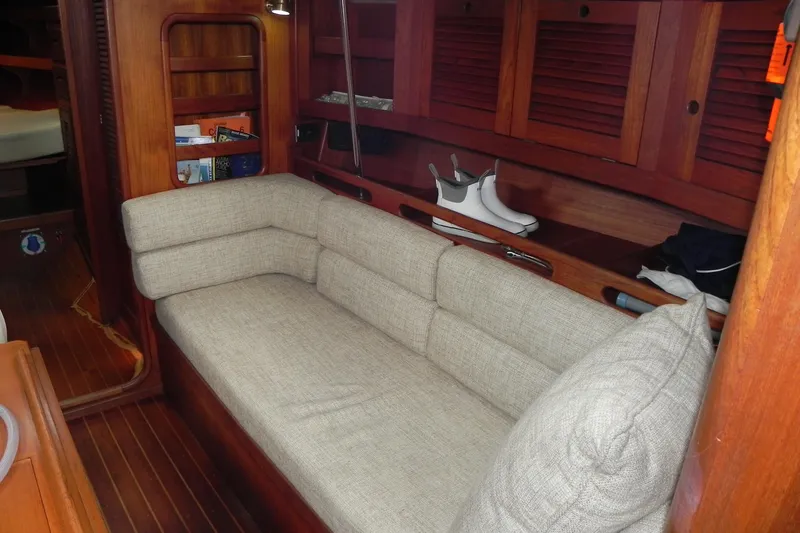 Cricket Yacht Photos Pics Interior of 1988 Tartan 40 sailboat with beige sofa and wooden cabinetry.