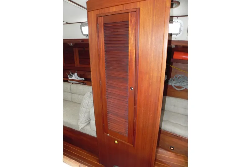 Cricket Yacht Photos Pics 1988 Tartan 40 yacht interior with wooden cabinetry and seating area.