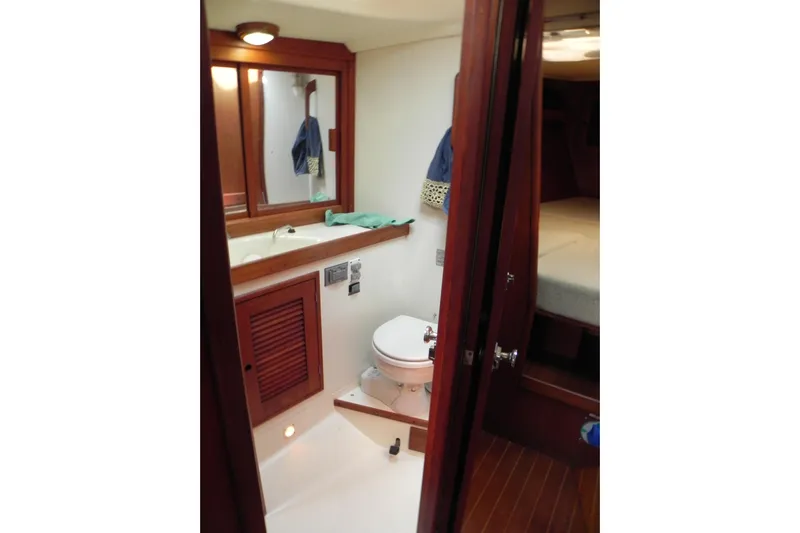 Cricket Yacht Photos Pics 1988 Tartan 40 yacht bathroom with wooden cabinetry and compact design.
