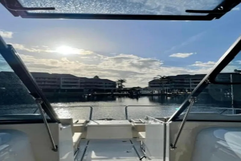  Yacht Photos Pics Aquila 36 Cruiser 2022 on water, scenic view through windshield, sunny day.